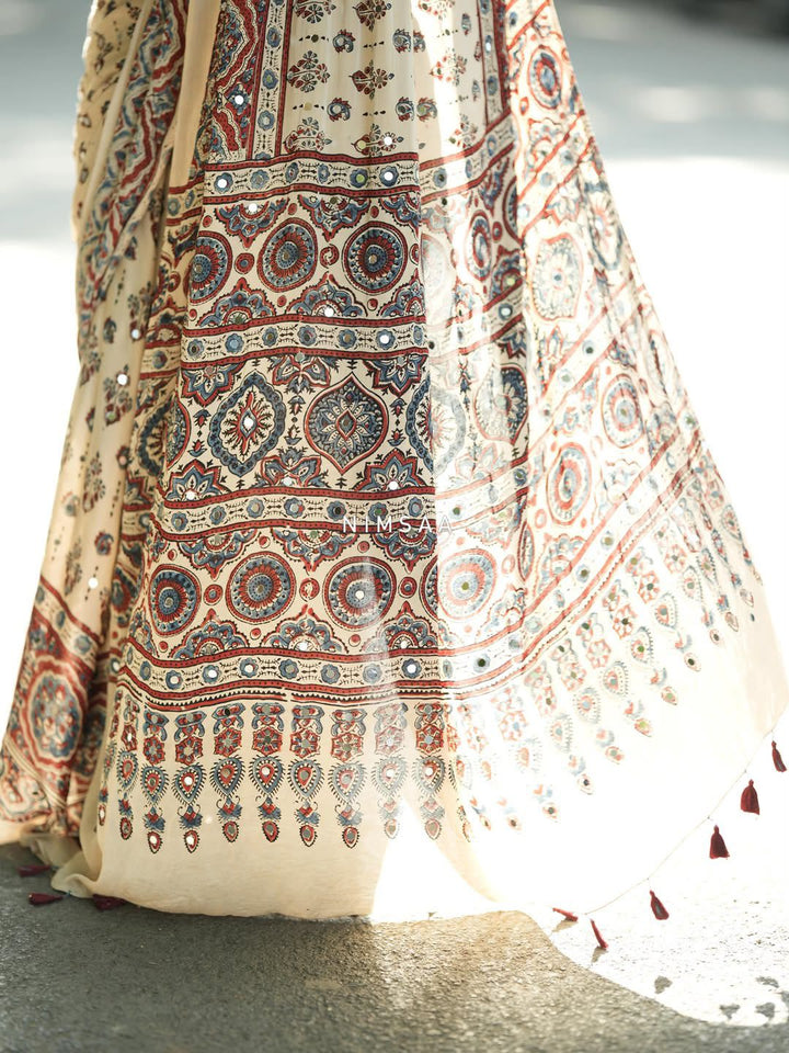 Ivory Modal Silk Ajrakh Printed Saree with Traditional Floral Motifs, Heritage Border &amp; Tassel Detailing