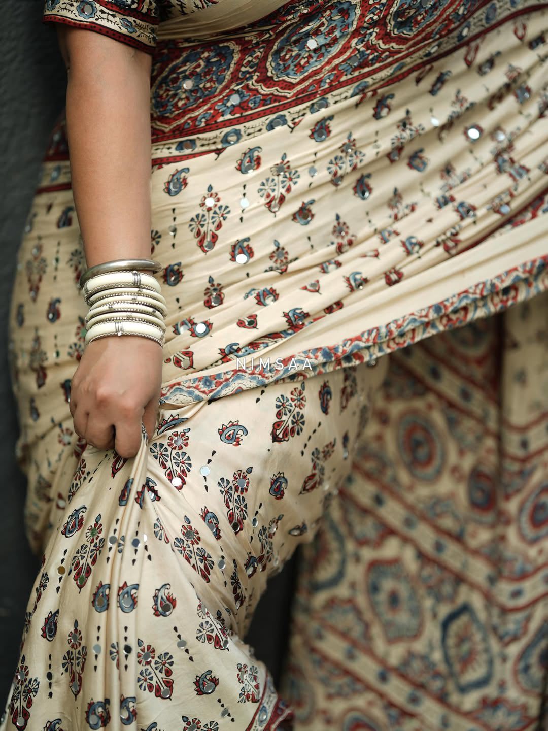 Ivory Modal Silk Ajrakh Printed Saree with Traditional Floral Motifs, Heritage Border &amp; Tassel Detailing