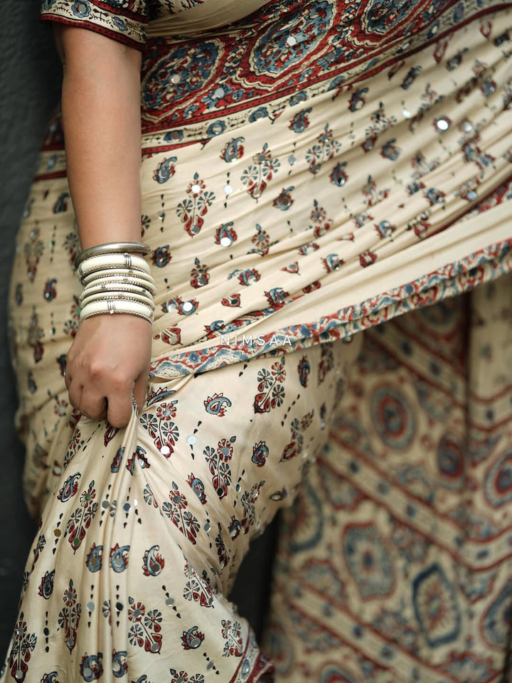 Ivory Modal Silk Ajrakh Printed Saree with Traditional Floral Motifs, Heritage Border &amp; Tassel Detailing