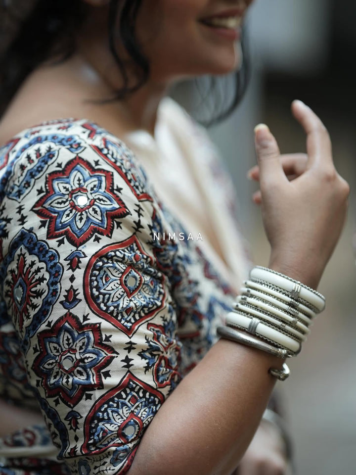 Ivory Modal Silk Ajrakh Printed Saree with Traditional Floral Motifs, Heritage Border &amp; Tassel Detailing